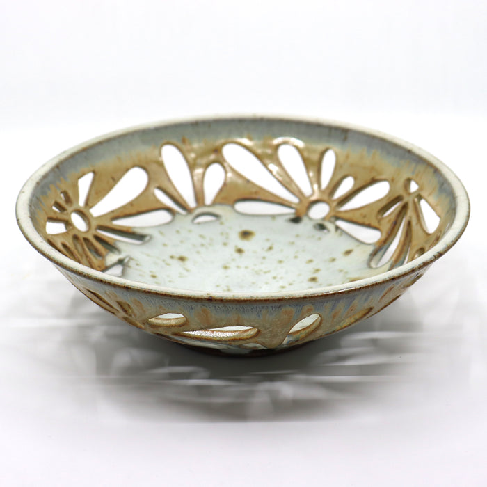 Handmade, wood-fired bowl with flower pattern cut-outs, by Heather Ossandon.