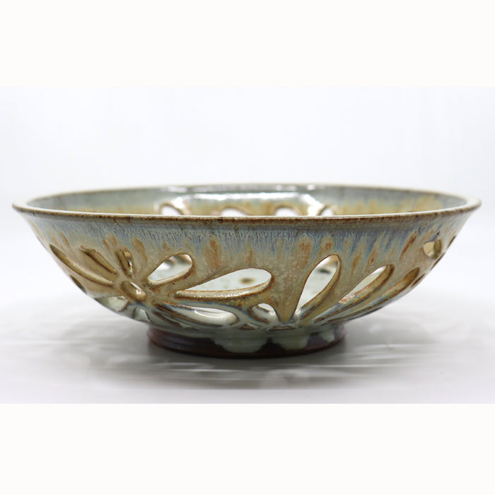 Handmade, wood-fired bowl with flower pattern cut-outs, by Heather Ossandon.