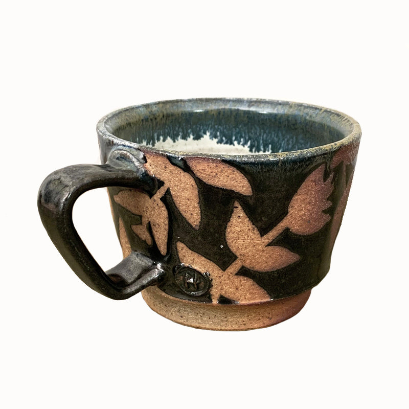 Woodfired creamic mug by Heather Ossandon, black and blue hues with rust flower pattern. Alternate view.