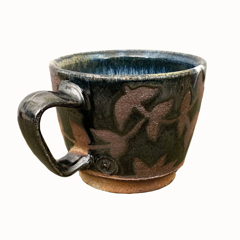 Woodfired creamic mug by Heather Ossandon, black and blue hues with rust flower pattern. Alternate view.