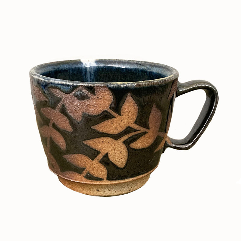 Woodfired creamic mug by Heather Ossandon, black and blue hues with rust flower pattern.