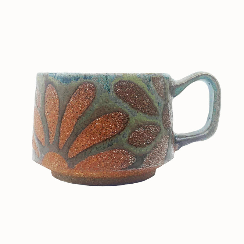 Heather Ossandon handmade, woodfired mug, side view. Rich, earthy hues with rust flower pattern.