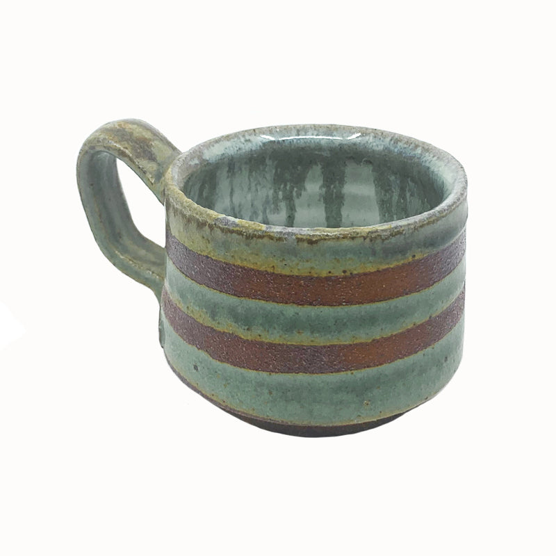 Heather Ossandon handmade, woodfired mug, angled view. Green with dark rust stripes.