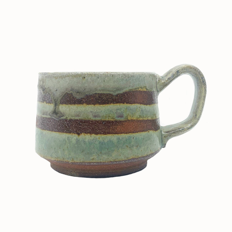 Heather Ossandon handmade, woodfired mug, side view. Green with dark rust stripes.