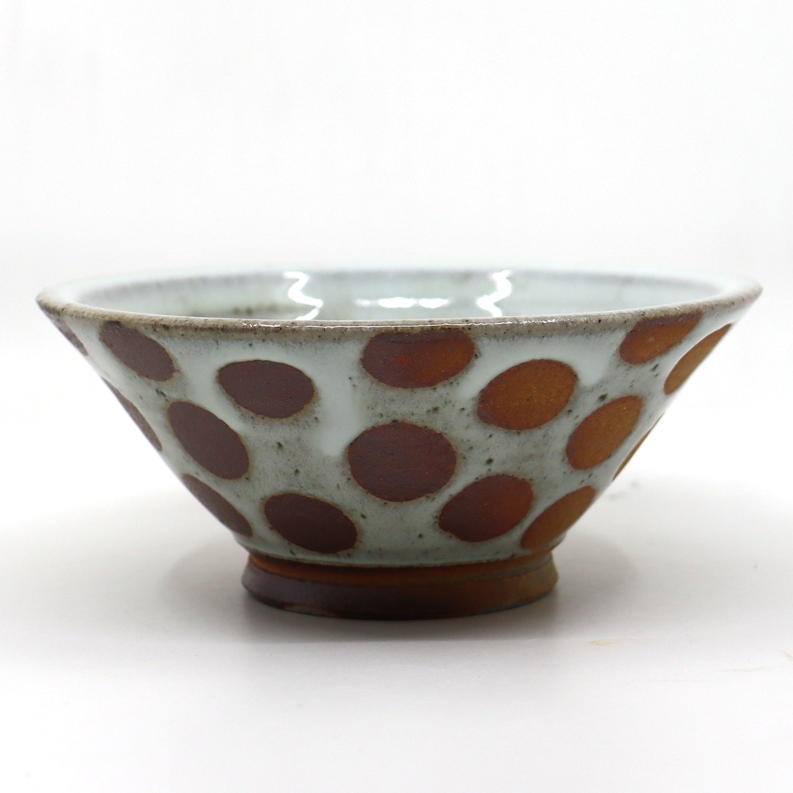 Handmade, wood-fired stoneware bowl with polka dots by Heather Ossandon