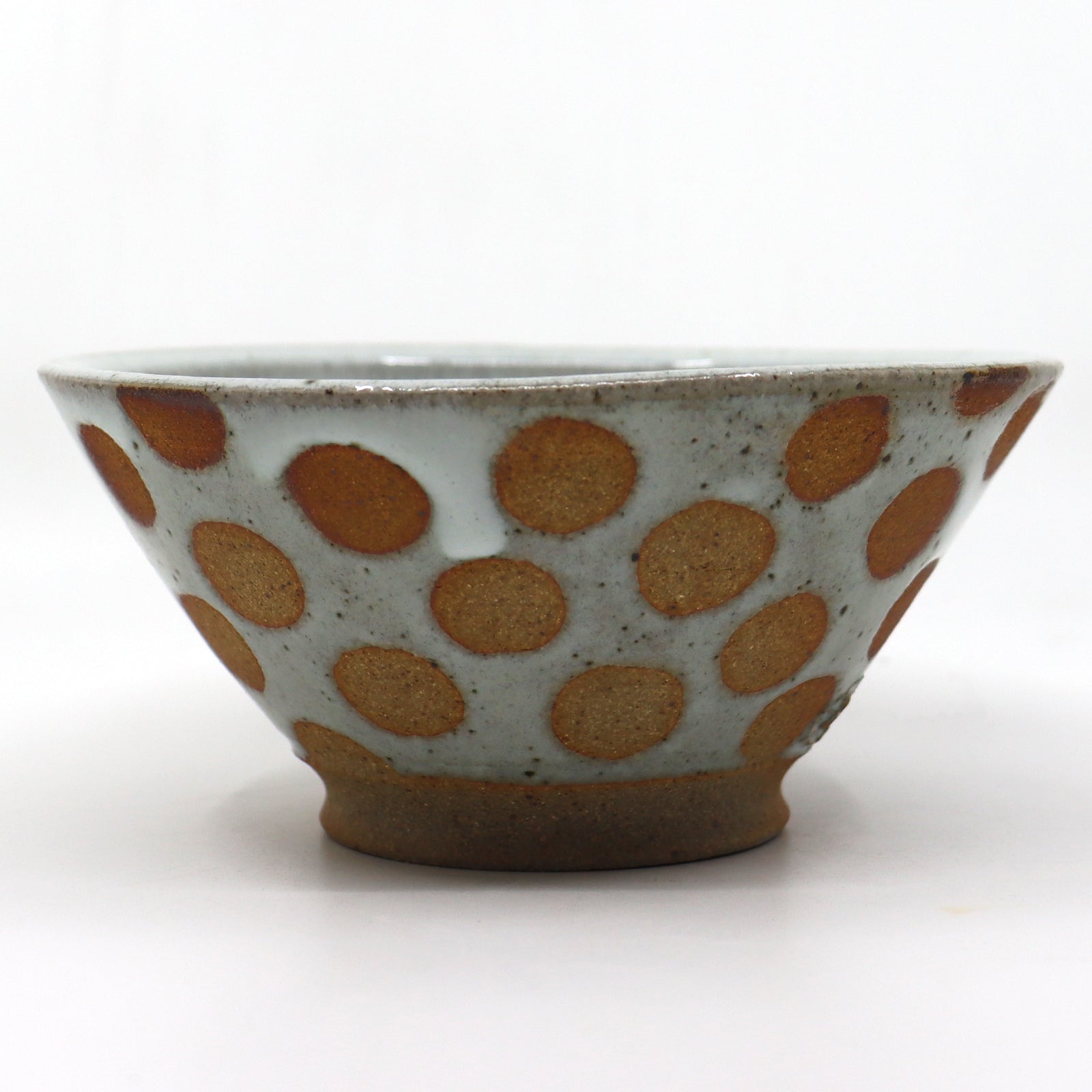 Handmade, wood-fired stoneware bowl with polka dots by Heather Ossandon