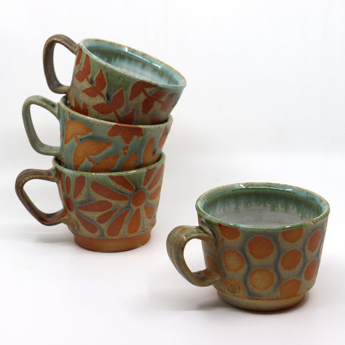 Handmade wood-fired stoneware mugs by Heather Ossandon.