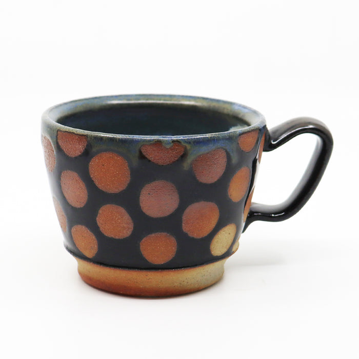 Handmade, wood-fired stoneware mug with polka dots by Heather Ossandon.