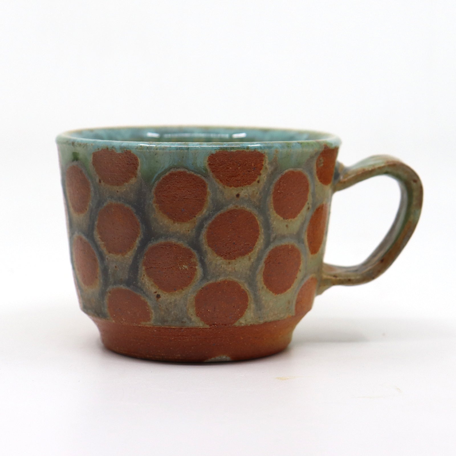 Handmade wood-fired, stoneware mug with polka dots by Heather Ossandon