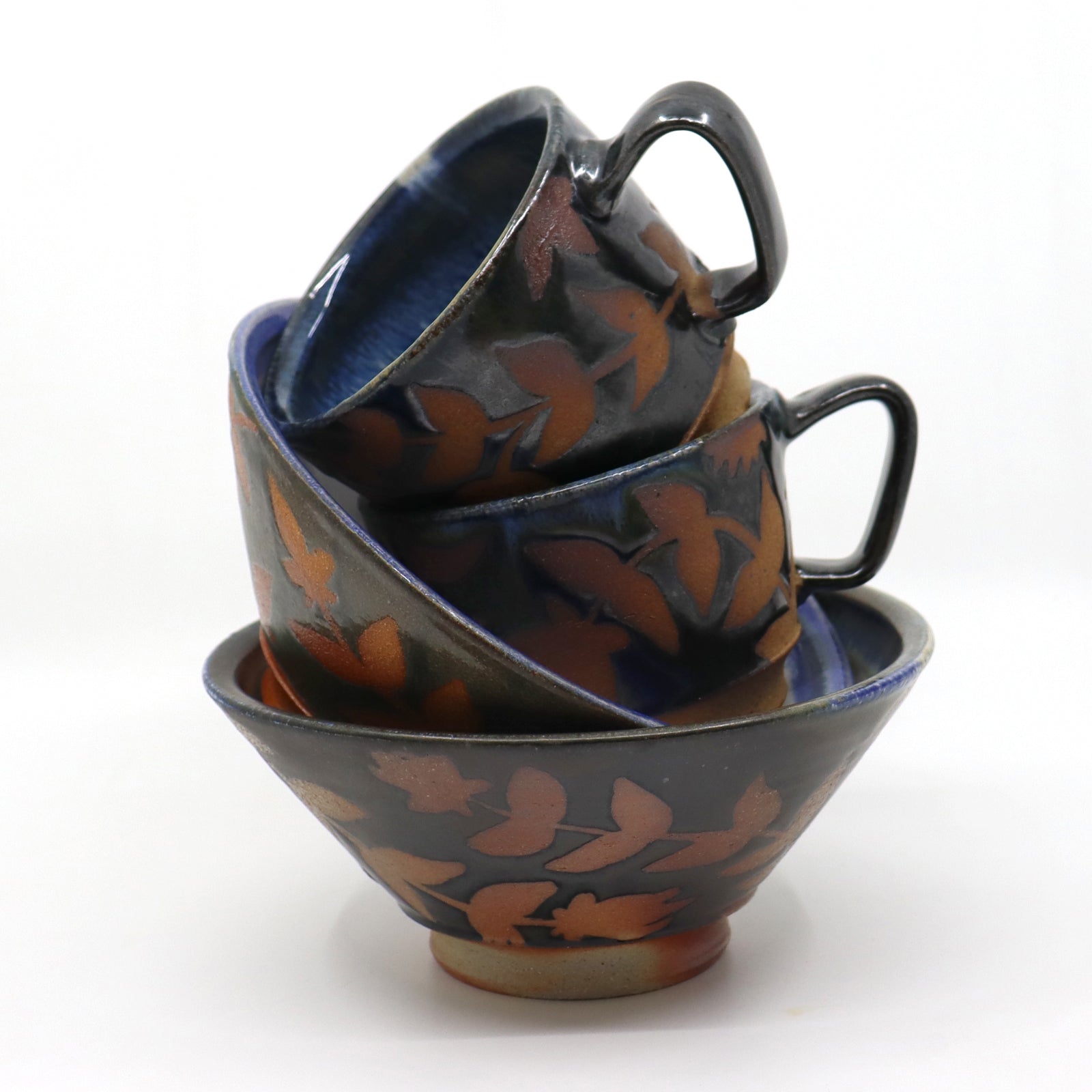 Handmade, wood-fired stoneware mugs and bowls with botanical patterns by Heather Ossandon.