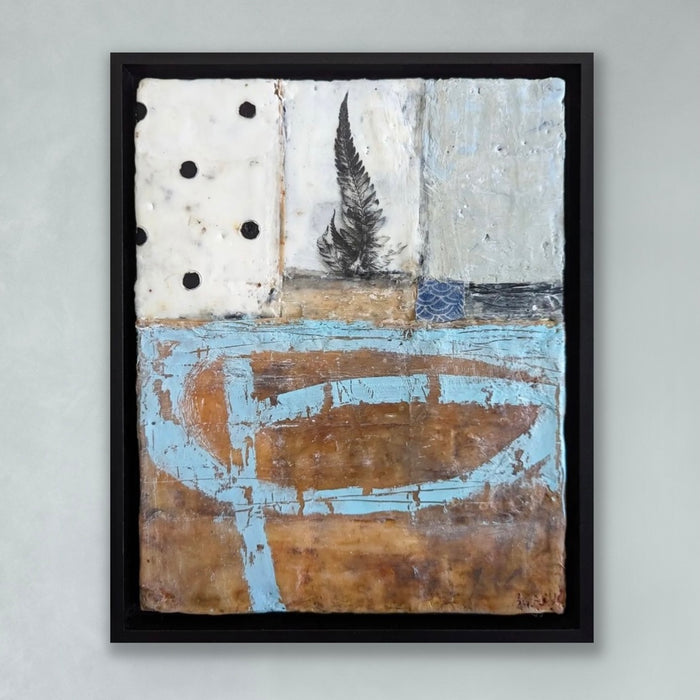 "In Love with Now" mixed media encaustic painting by Bridgette Guerzon Mills. The painting has small fern near the top on a creamy white background and earth tone bottom. There are black polk dot and blue details.