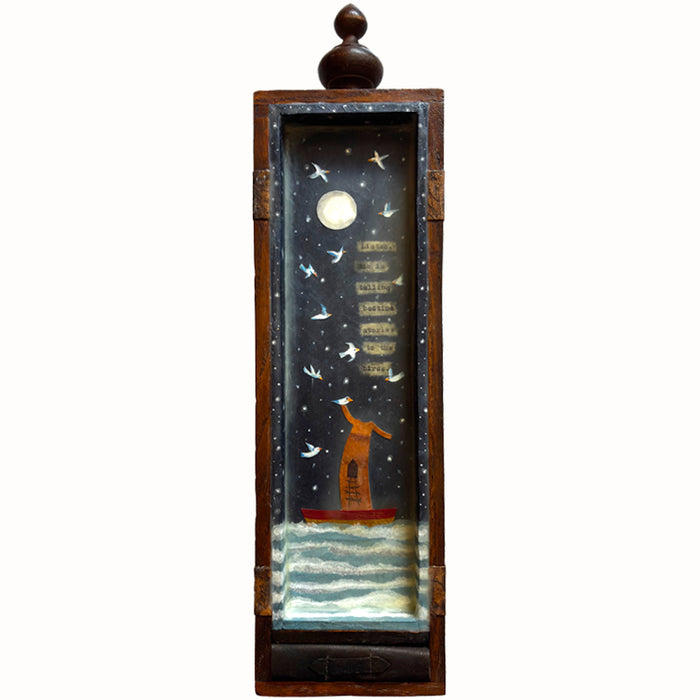 Tall, narrow box with finial on top, mixed media encaustic artwork encased inside, and a small handmade book. Artwork by Janet Eskridge. 
