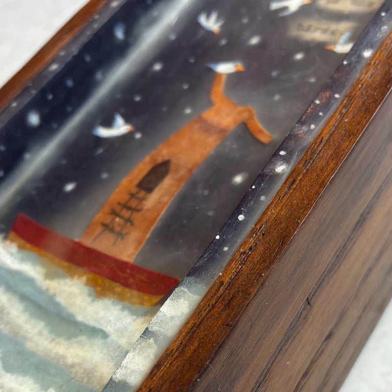 Tall, narrow box with finial on top, mixed media encaustic artwork encased inside, and a small handmade book. Artwork by Janet Eskridge. Close up detail. 