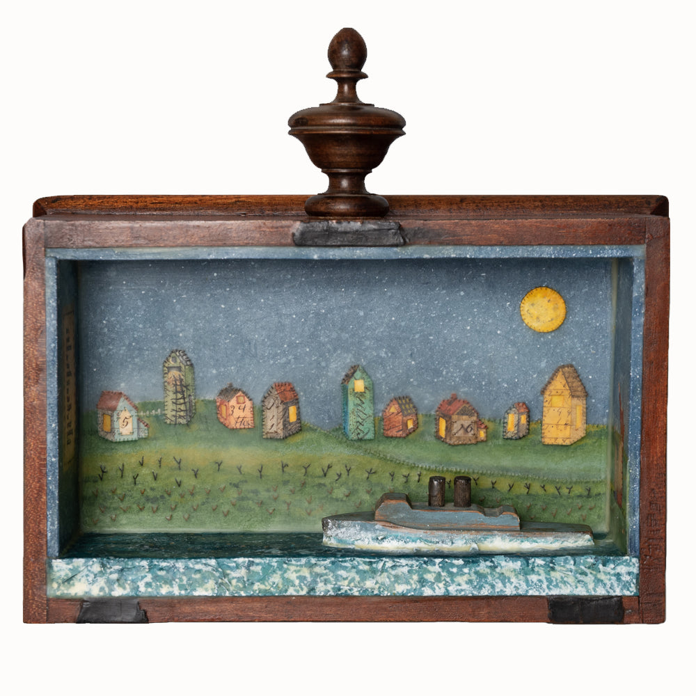 "By the Stars" mixed media encaustic assemblage by Janet Eskridge. A wooden box with top finial, Janet's artwork fills the interior - a row of houses under a full moon and star filled sky, with a wooden boat in the water. 