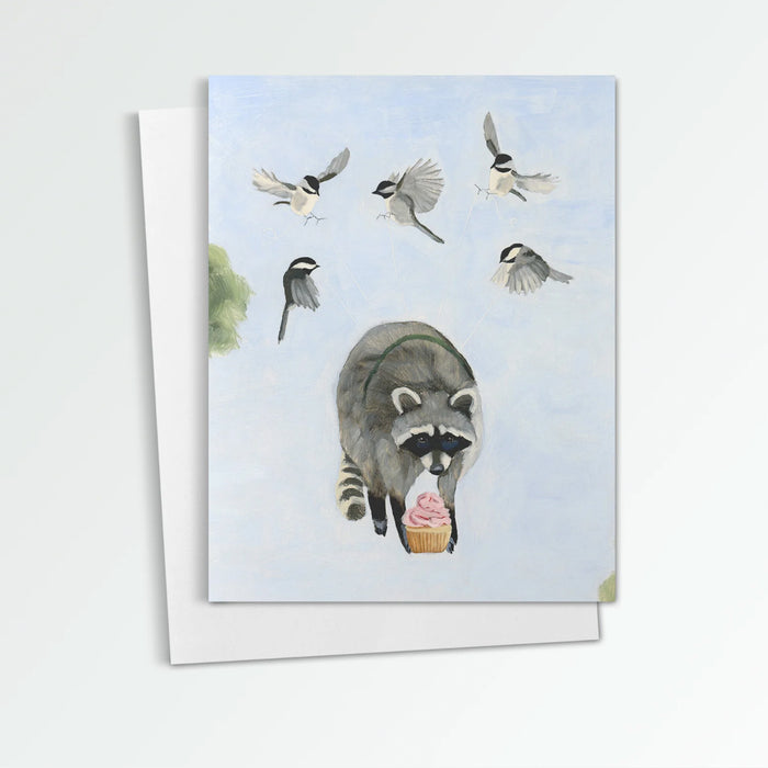 C is for Cupcake & Carefully Planned Getaways notecard from Kim Ferreira. A raccoon, holding a cupcake, is uplifted into the sky by a group of chickadees.