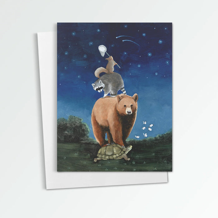 Catch a Shooting Star notecard from Kim Ferreira. A turtle, bear and raccoon form the base for a squirrel to stand upon to try and catch a shooting star.