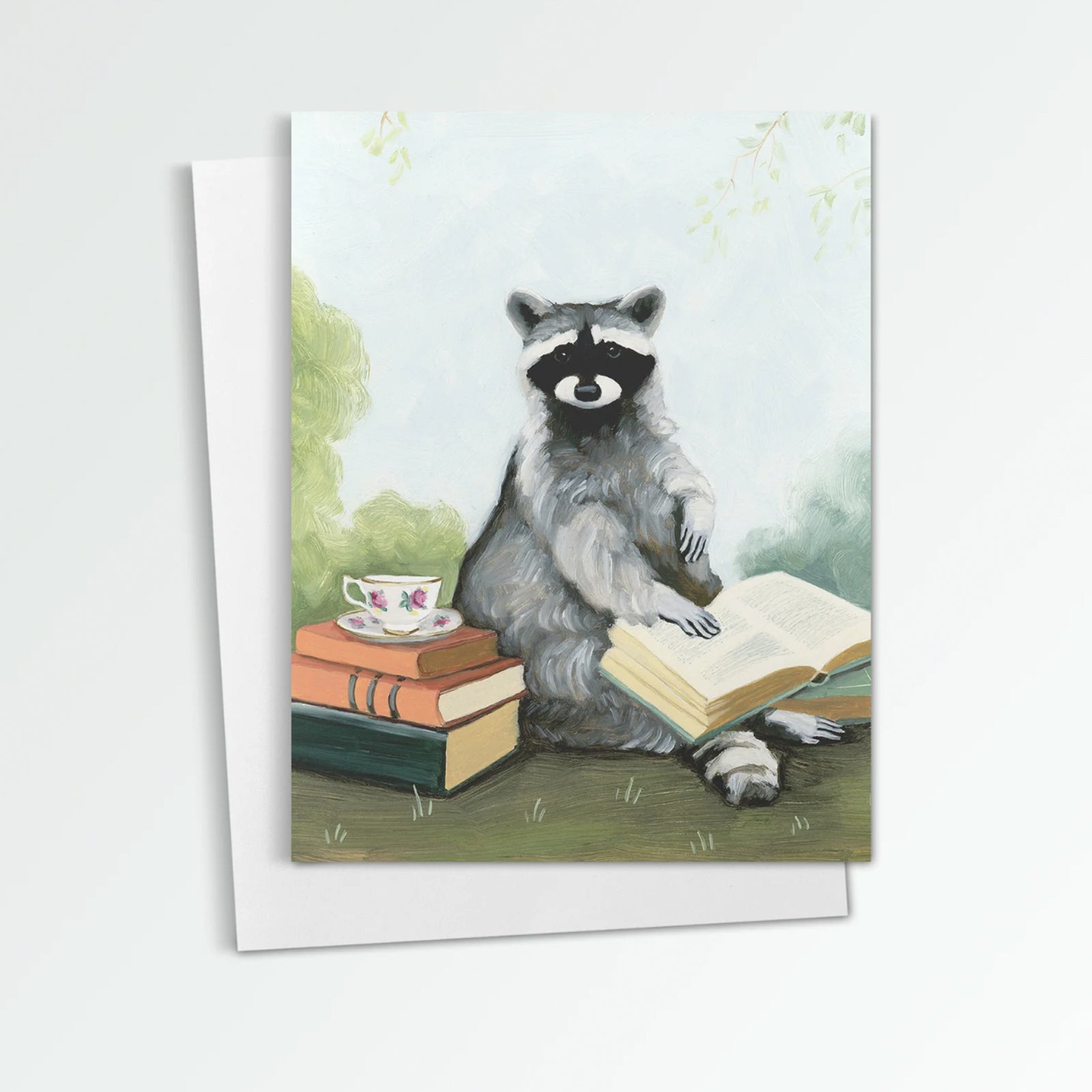 Tea & Books notecard from Kim Ferreira. A raccoon sits with a stack of books and cup of tea.