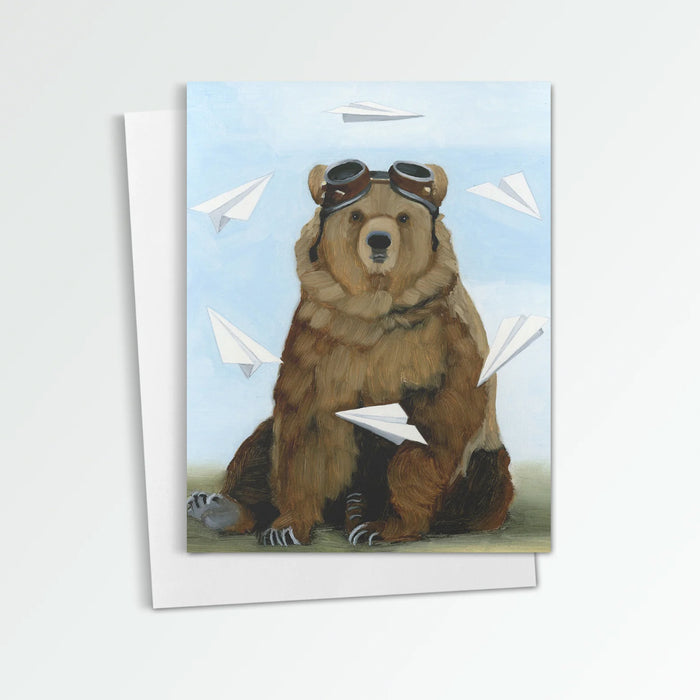 Aeronaut notecard from Kim Ferreira. Bear wearing aviation goggles, surrounded by paper airplanes.