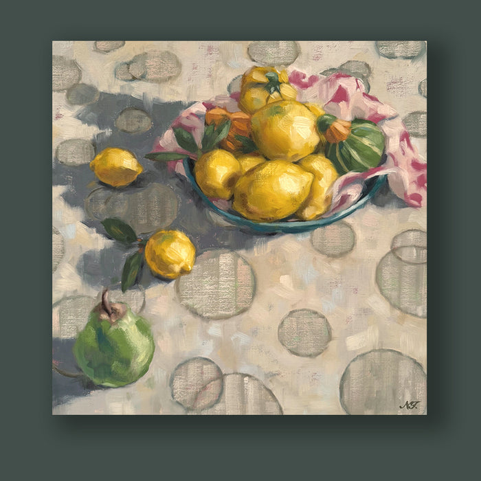 Lemons, Squash and a Pear still life painting by Ninalee Irani. The 16 x 16" oil panel painting features a bowl filled with lemons and squash, with a couple of lemons and a pear on the tabletop - which is covered in a cloth with a circular pattern. The painting is displayed on a dark green wall. 