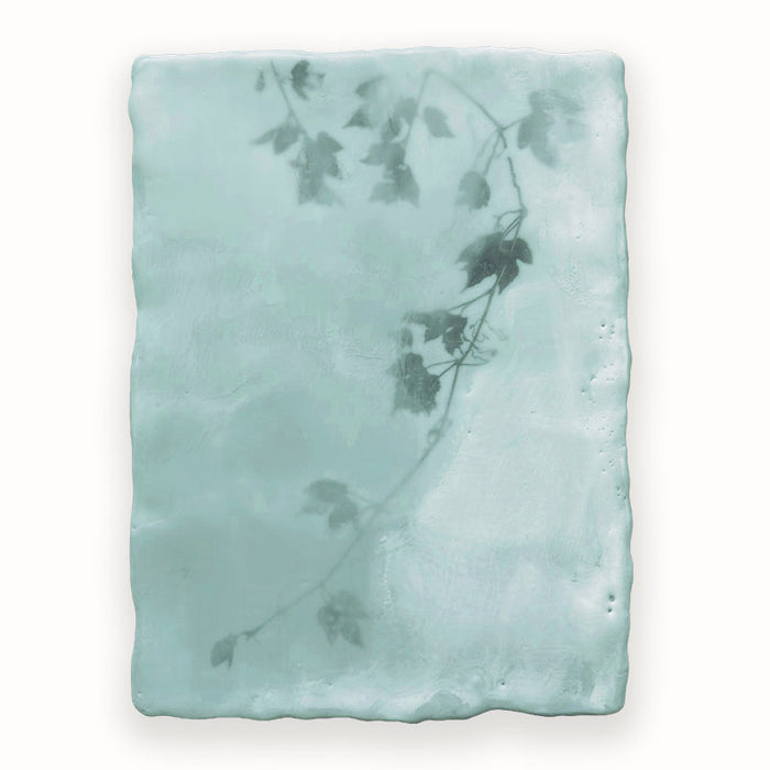 Mixed media encaustic painting by Liberty Hanson Wild in pale green and white with leafy branch detail. 