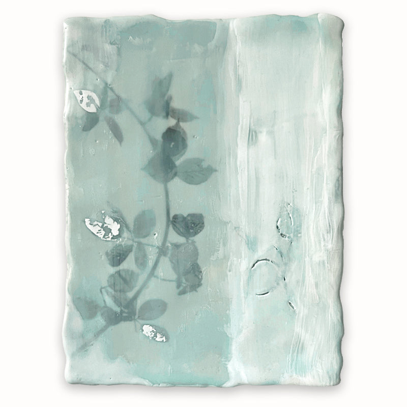 Mixed media encaustic painting by Liberty Hanson Wild in soft green and white with leafy branch and silver leaf detail.