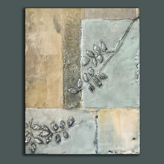 Mixed media encaustic artwork from Liberty Hanson-Wild's series called Yesterday's Seeds.  An abstracted background in neutral colors with textures and leaf pattern with silver. Painting shown on dark teal wall. 