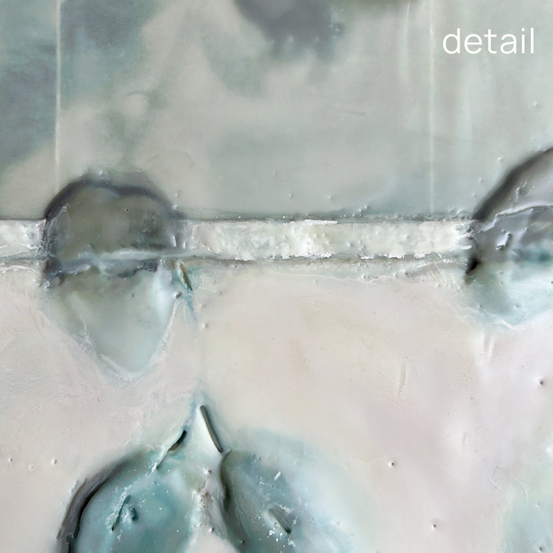 Detail of mixed media encaustic artwork with creamy white and pale green leaf pattern, with subtle silver leaf detail.
