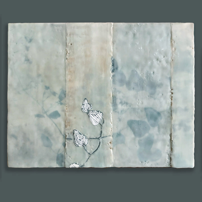 Mixed media encaustic artwork on panel, soft neutral tones in grid pattern with leaves and silver detail. Shown on dark teal wall. 