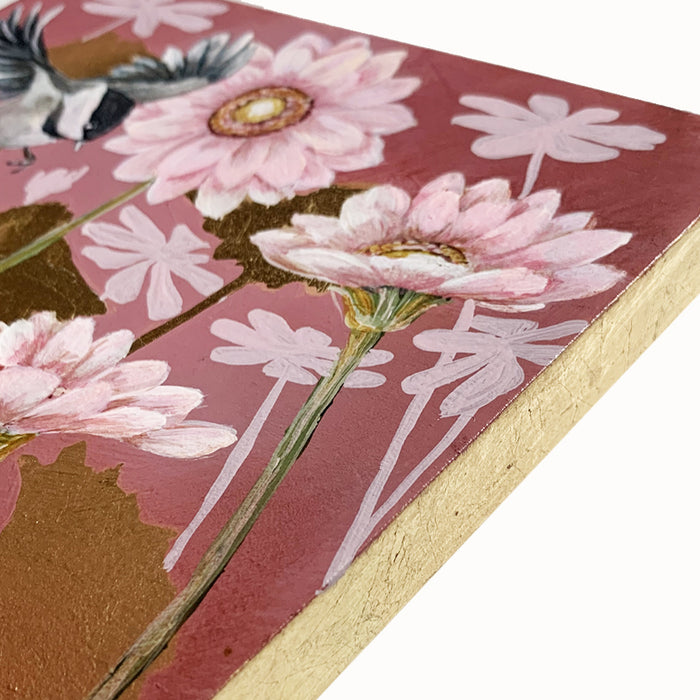 "Garden Friends 2" painting by artist Lynne Miller. The 8 x 8" acrylic and gold leaf painting features a chickadee, light pink daisies and a bee, with gold leaf details. Gold leaf side detail.