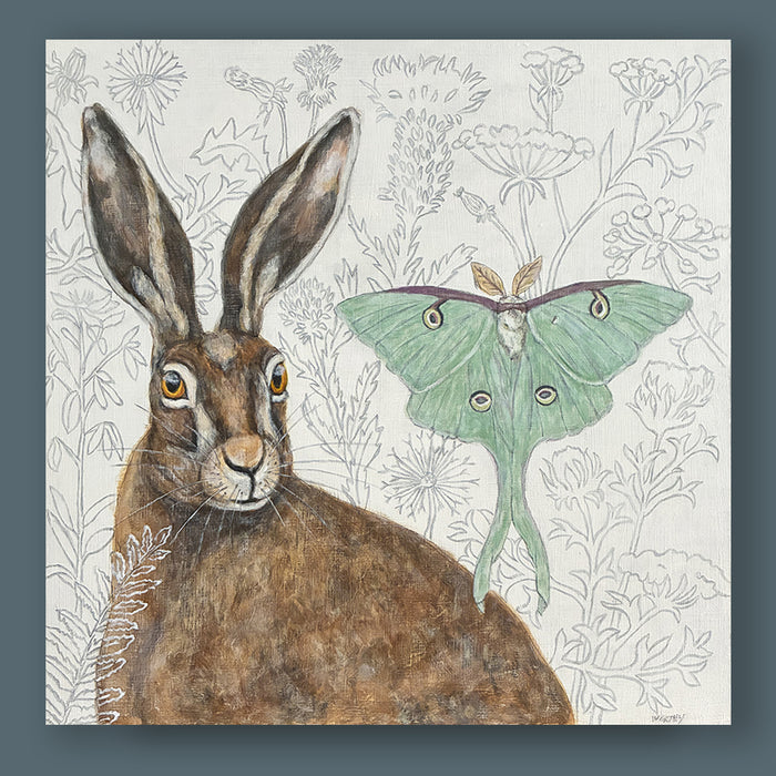 Messengers of Hope painting by Martha Worthy featuring a hare and luna moth, with a botanical themed backdrop. Artwork showcased on blue wall.