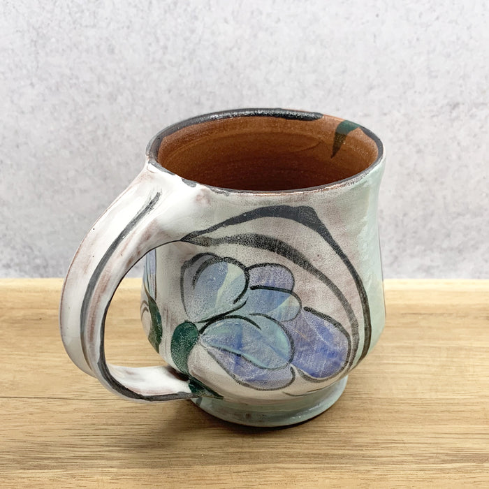 Handmade ceramic mug with flower decoration by Molly Lithgo. Made in North Carolina. 