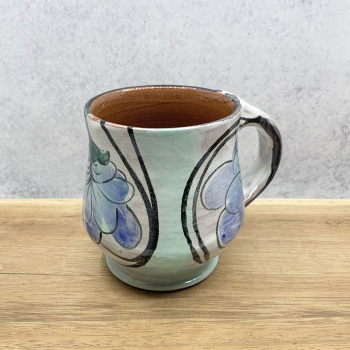 Handmade ceramic mug with flower decoration by Molly Lithgo. Made in North Carolina.