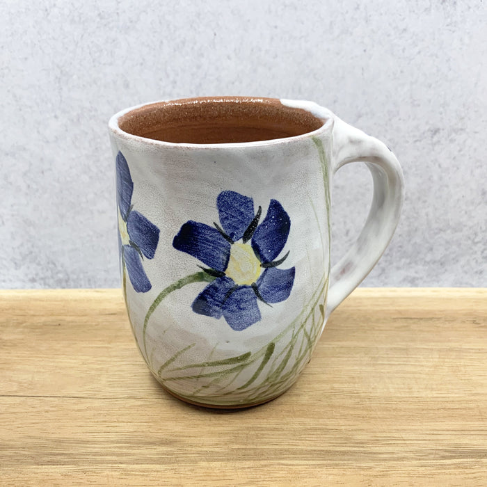 Handmade ceramic mug with flower decoration by Molly Lithgo. Made in North Carolina.