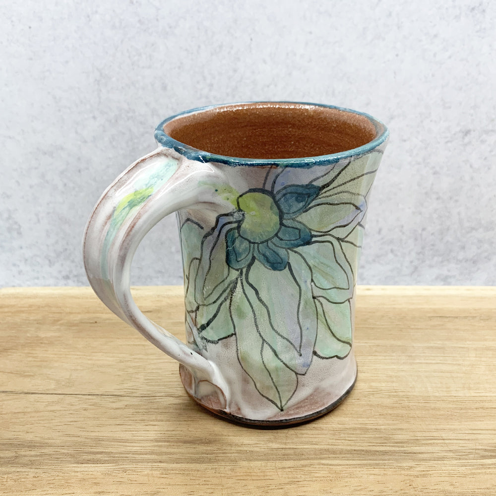 Handmade ceramic mug with flower decoration by Molly Lithgo. Made in North Carolina. 