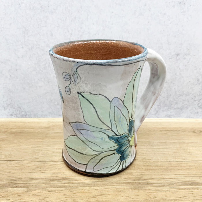 Handmade ceramic mug with flower decoration by Molly Lithgo. Made in North Carolina.