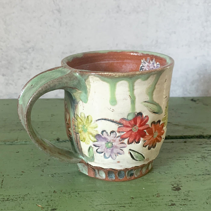 Handmade ceramic mug with multi color stamped flower decoration by Molly Lithgo. Made in North Carolina. View 2.