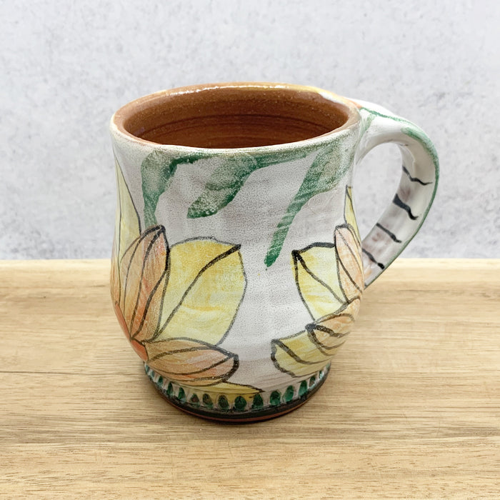 Handmade ceramic mug with flower decoration by Molly Lithgo. Made in North Carolina.