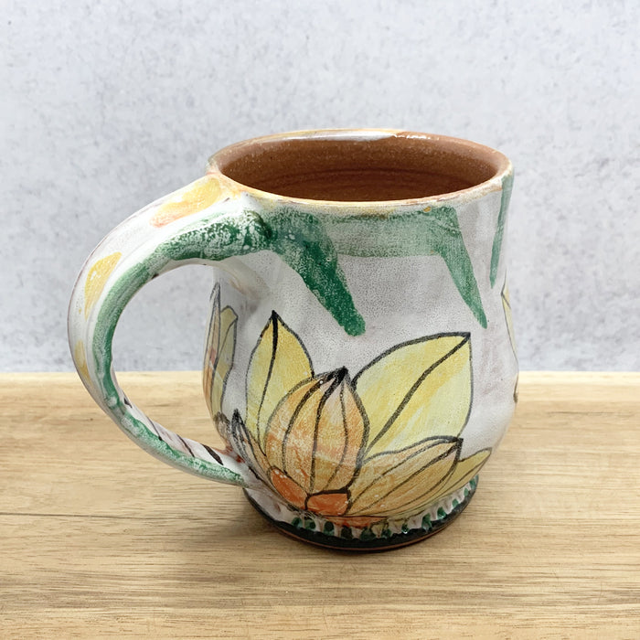 Handmade ceramic mug with flower decoration by Molly Lithgo. Made in North Carolina. 