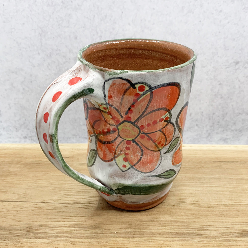 Handmade ceramic mug with flower decoration by Molly Lithgo. Made in North Carolina. 