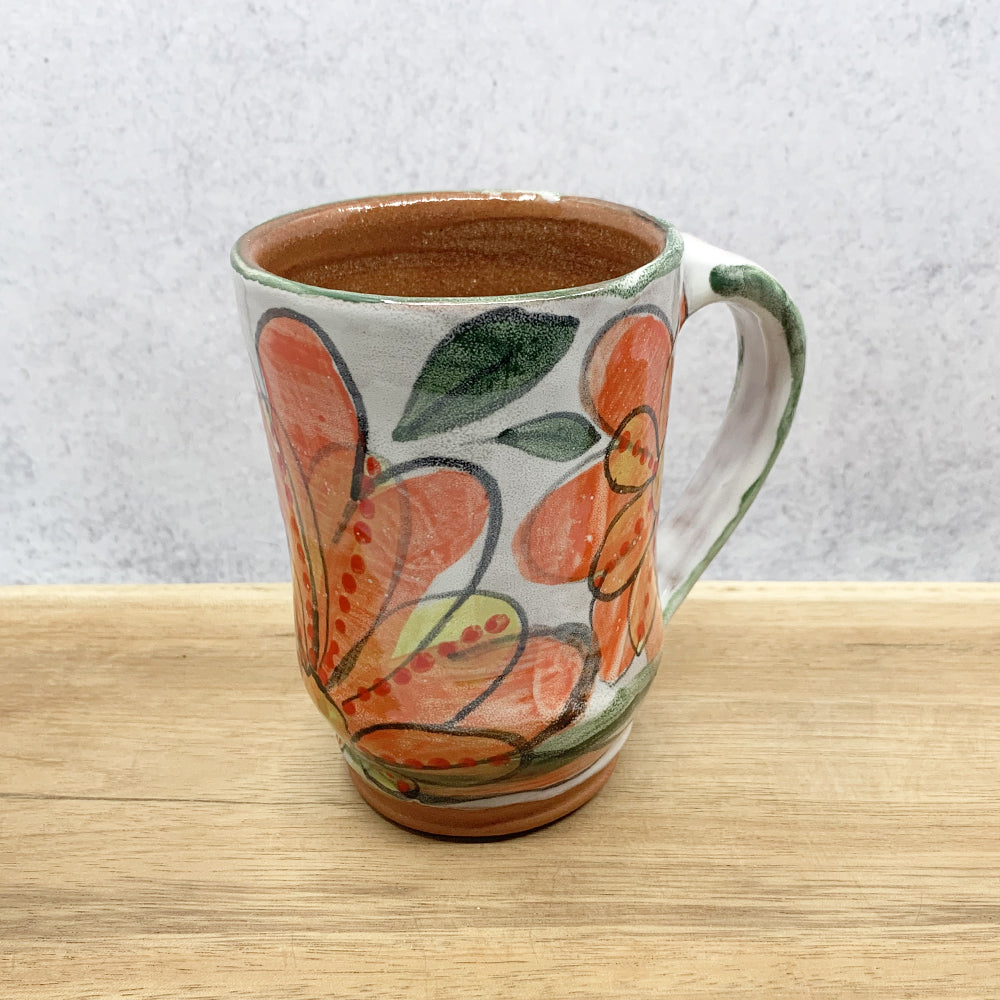 Handmade ceramic mug with flower decoration by Molly Lithgo. Made in North Carolina.