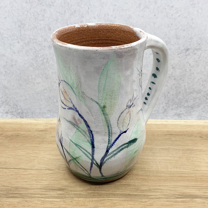 Handmade ceramic mug with flower decoration by Molly Lithgo. Made in North Carolina.