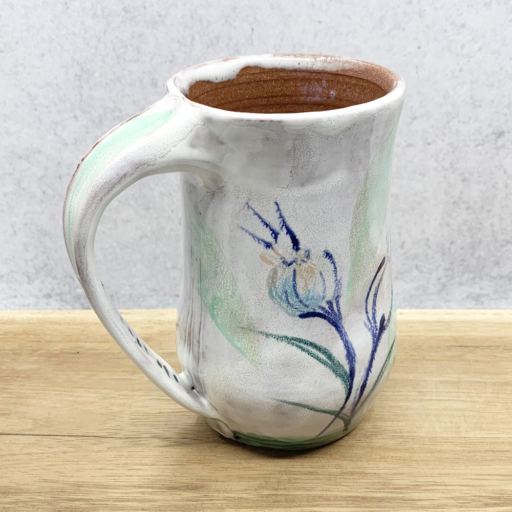 Handmade ceramic mug with flower decoration by Molly Lithgo. Made in North Carolina. 