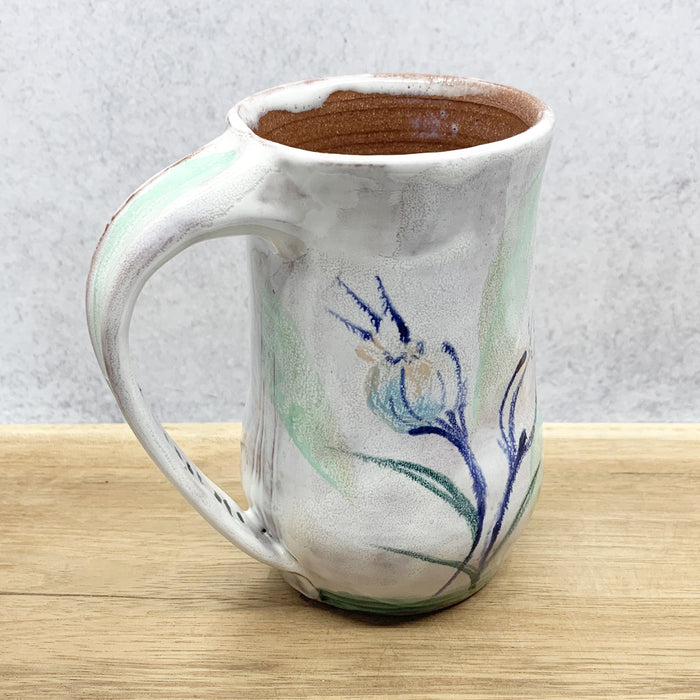 Handmade ceramic mug with flower decoration by Molly Lithgo. Made in North Carolina. 