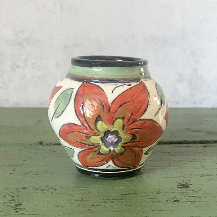 Mini handmade bud vase with dark orange flowers by Molly Lithgo. Made in NC.