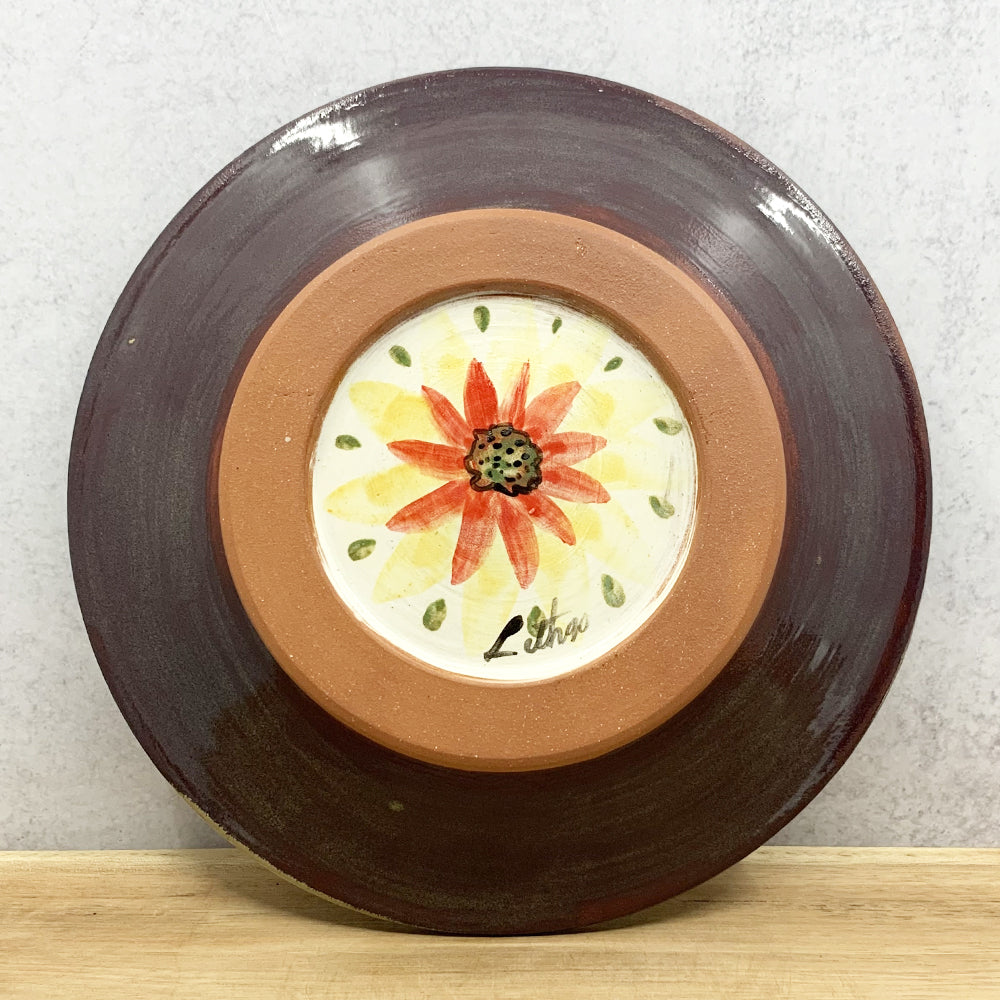 Handmade ceramic bowl with interior flower design by Molly Lithgo. Made in North Carolina. Bottom view.