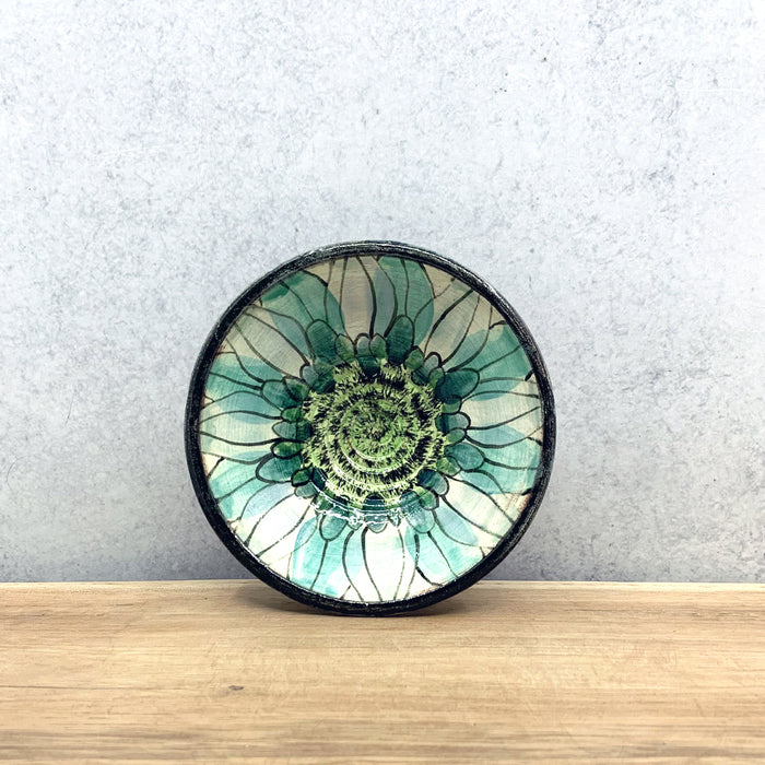 Small handmade ceramic bowl with flower decoration by Molly Lithgo. Made in North Carolina.