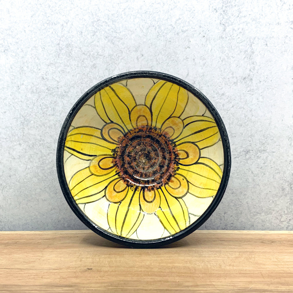 Small handmade ceramic flower bowl with interior flower decoration by Molly Lithgo. Made in North Carolina.