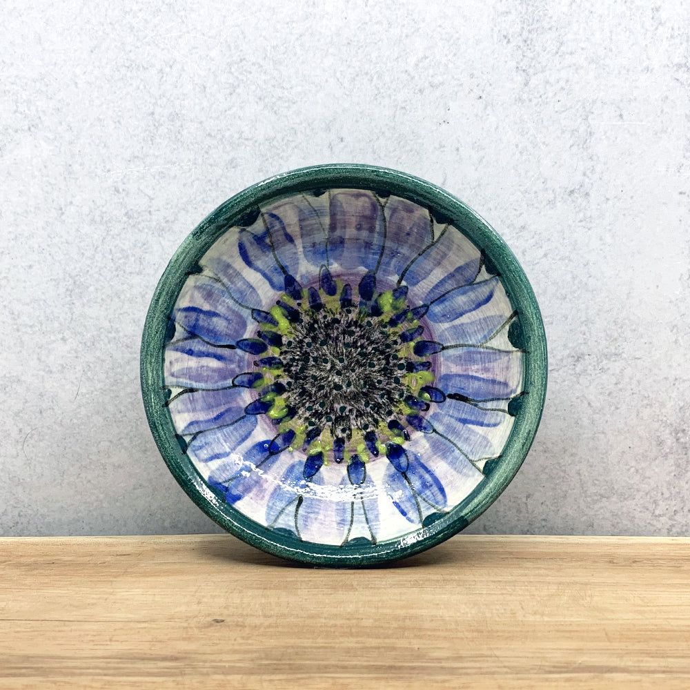 Small, handmade ceramic bowl with interior flower decoration by Molly Lithgo. Made in North Carolina.