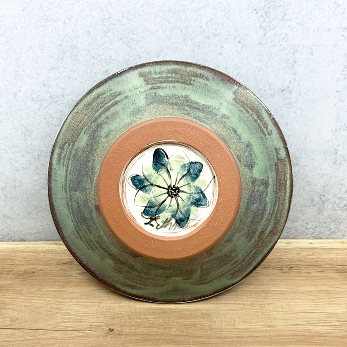 Handmade ceramic bowl with interior flower design by Molly Lithgo. Made in North Carolina. Bottom view.