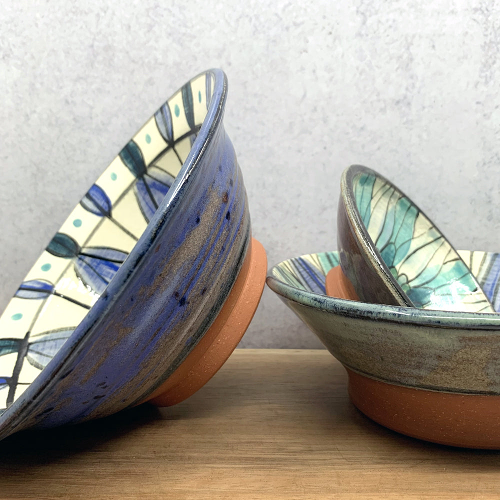 andmade ceramic bowls with interior flower decoration by Molly Lithgo. Made in North Carolina. 